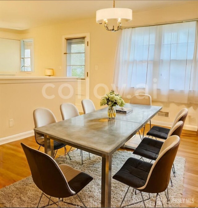 dining space featuring a chandelier and light wood-type flooring