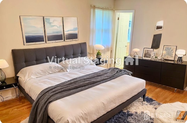 bedroom with hardwood / wood-style flooring