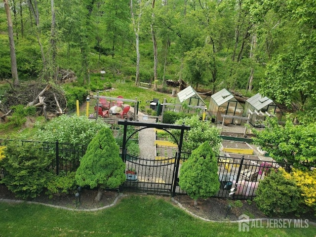 view of gate with an outdoor structure and fence