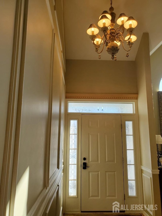 foyer entrance featuring an inviting chandelier