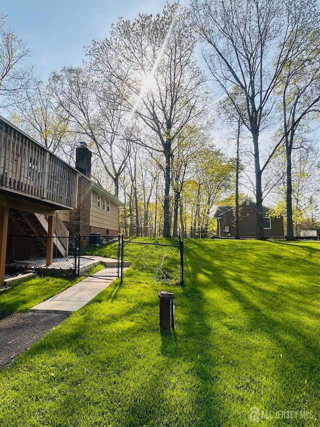 view of home's community with stairway, fence, a yard, and a deck