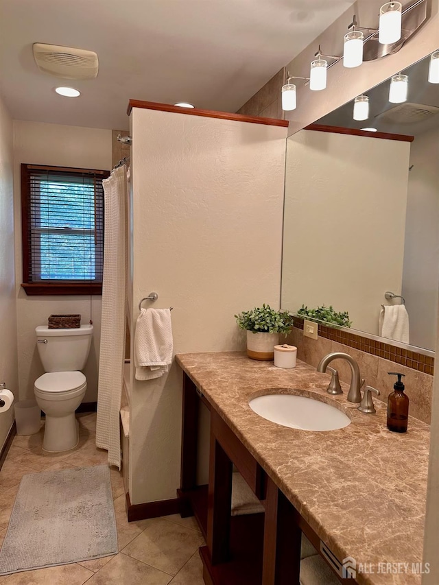 full bathroom featuring toilet, tile patterned floors, curtained shower, and vanity