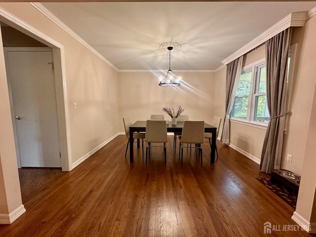 dining room with an inviting chandelier, baseboards, ornamental molding, and dark wood-type flooring