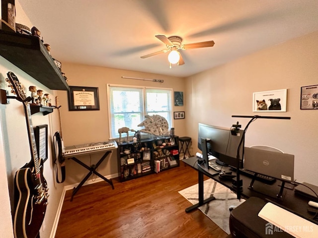 workout room with a ceiling fan and wood finished floors