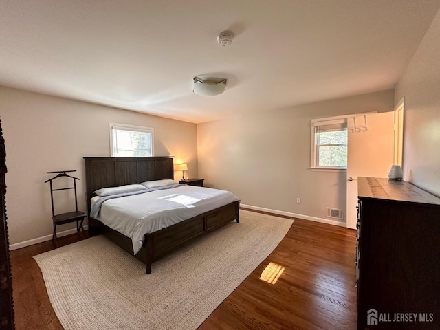 667 Cedarbrook Rd, Bridgewater, NJ 08807 - bedroom with dark wood-style flooring and baseboards