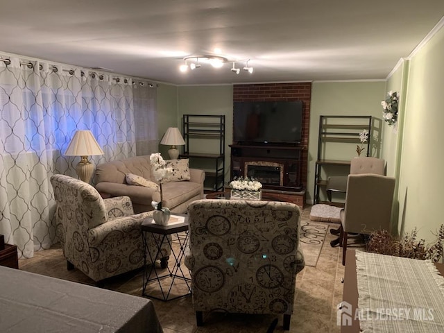 living area with a fireplace and ornamental molding