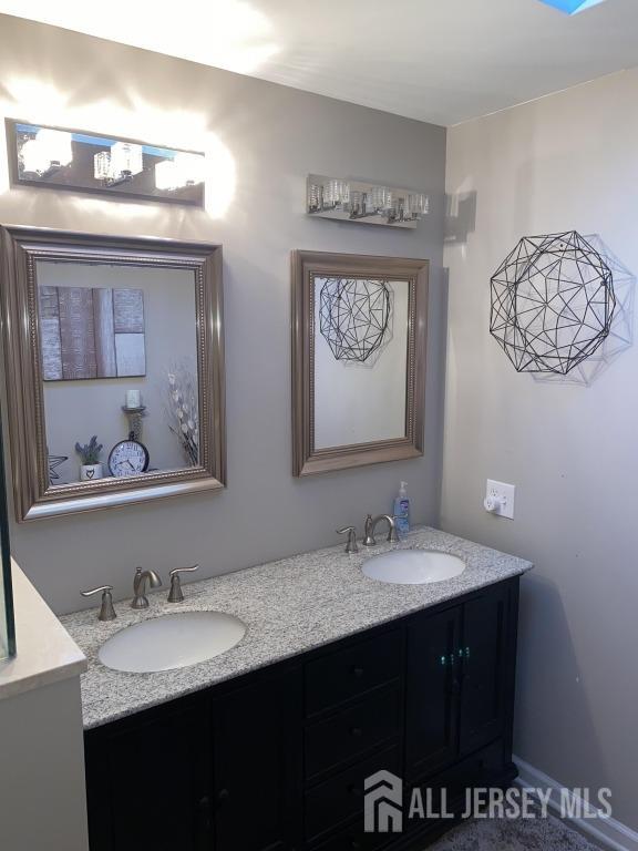 bathroom featuring a sink and double vanity