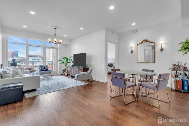 living room featuring dark wood-type flooring, recessed lighting, a chandelier, and baseboards