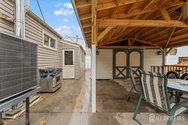 view of patio featuring a shed