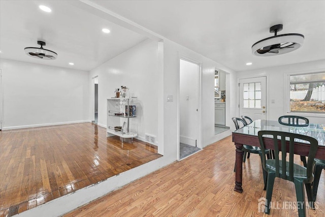 dining room with light hardwood / wood-style flooring and ceiling fan