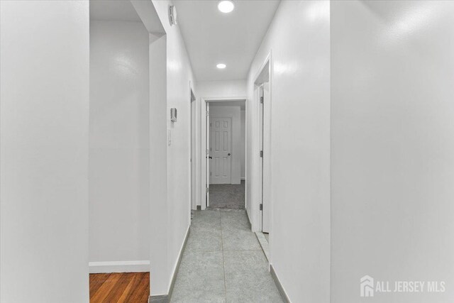 corridor with light hardwood / wood-style floors