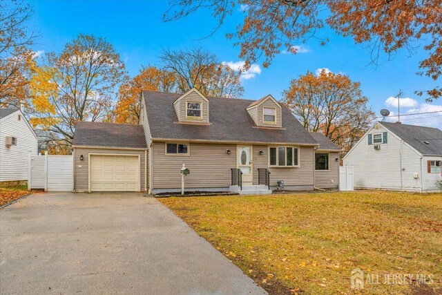 new england style home with a garage and a front lawn