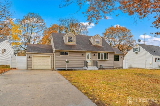 cape cod-style house featuring a garage, driveway, fence, and a front yard