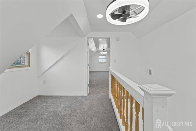 hall featuring carpet floors and lofted ceiling