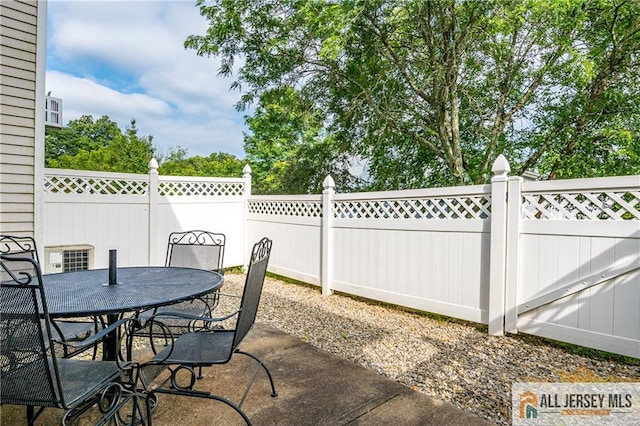 303 Harvest Ln, South Brunswick, NJ 08852 - fenced backyard featuring outdoor dining space and a patio area