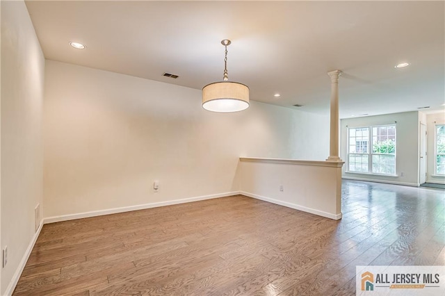 303 Harvest Ln, South Brunswick, NJ 08852 - unfurnished room with ornate columns, wood finished floors, and recessed lighting