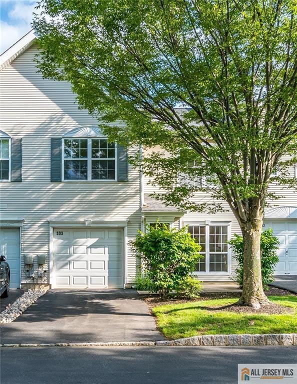 303 Harvest Ln, South Brunswick, NJ 08852 - view of front of house featuring asphalt driveway and an attached garage