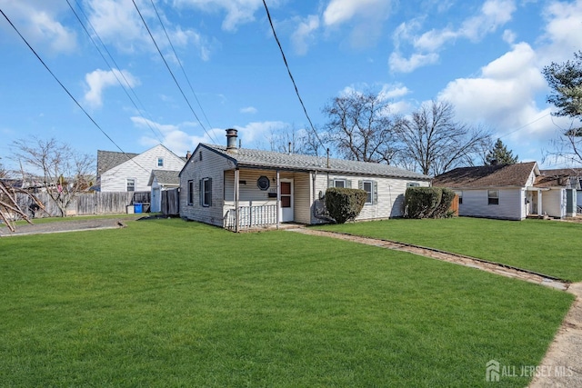 ranch-style house with a front lawn and fence