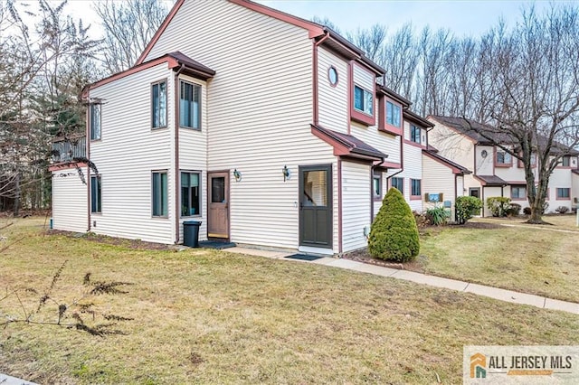 rear view of property with a yard