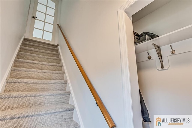 stairway featuring baseboards