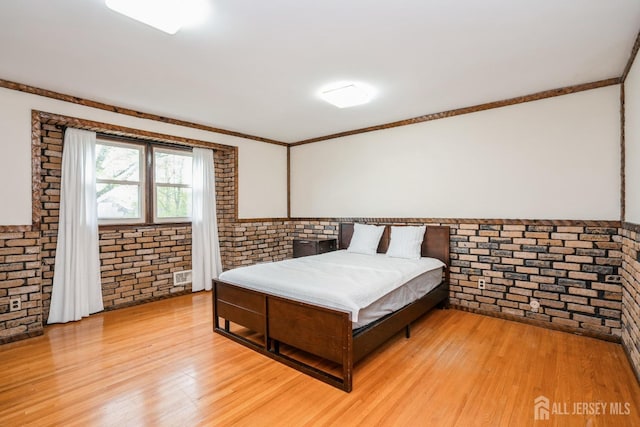 8 Appletree Ln, East Brunswick, NJ 08816 - bedroom featuring brick wall, light wood-style floors, and crown molding