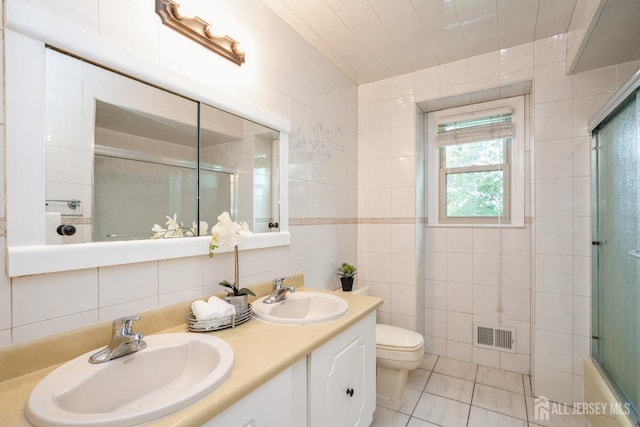 8 Appletree Ln, East Brunswick, NJ 08816 - bathroom with a shower with shower door, tile walls, toilet, double vanity, and tile patterned floors