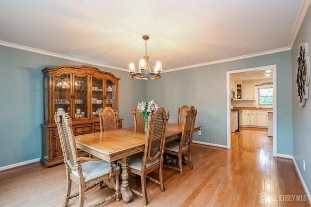 8 Appletree Ln, East Brunswick, NJ 08816 - dining area featuring a chandelier, light wood-style flooring, crown molding, and baseboards