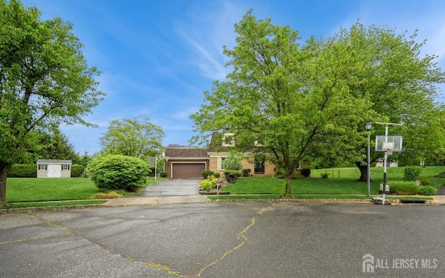 8 Appletree Ln, East Brunswick, NJ 08816 - obstructed view of property with a garage, asphalt driveway, and a front yard