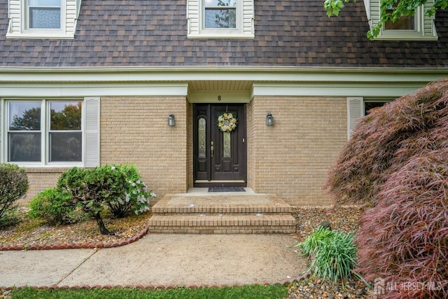 8 Appletree Ln, East Brunswick, NJ 08816 - doorway to property with a shingled roof, brick siding, and mansard roof