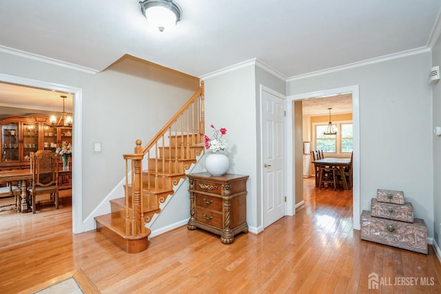 8 Appletree Ln, East Brunswick, NJ 08816 - staircase with a chandelier, wood finished floors, ornamental molding, and baseboards