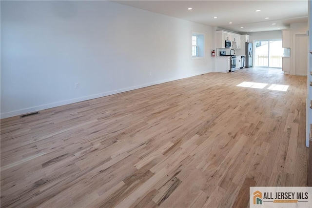 unfurnished living room with light hardwood / wood-style flooring