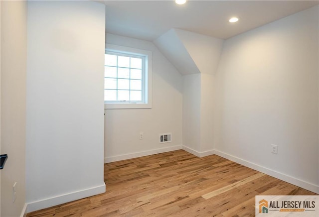 additional living space featuring light wood-type flooring