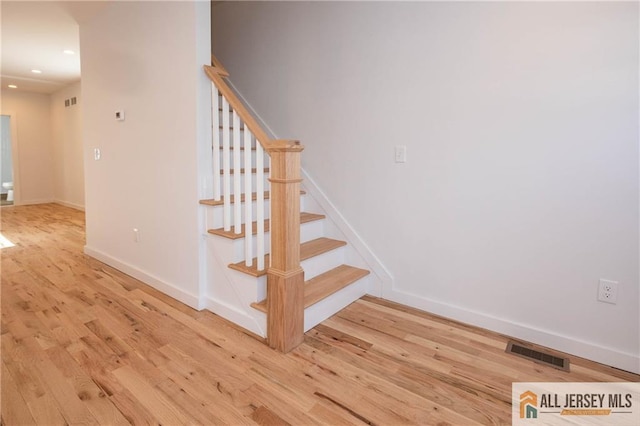 stairway featuring wood-type flooring