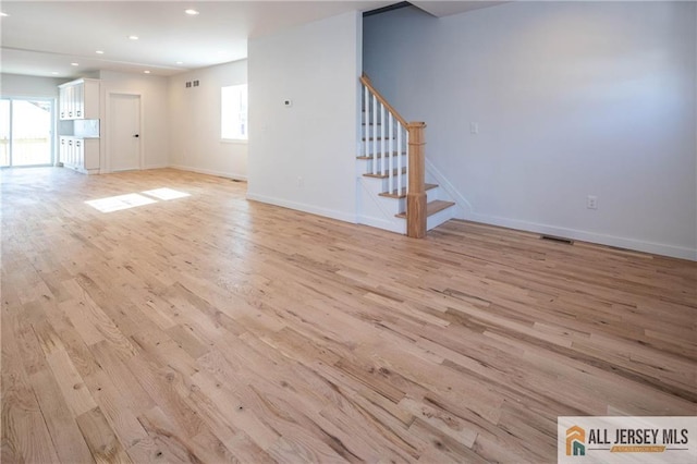 unfurnished living room with light hardwood / wood-style flooring