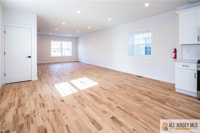 unfurnished living room with light hardwood / wood-style flooring