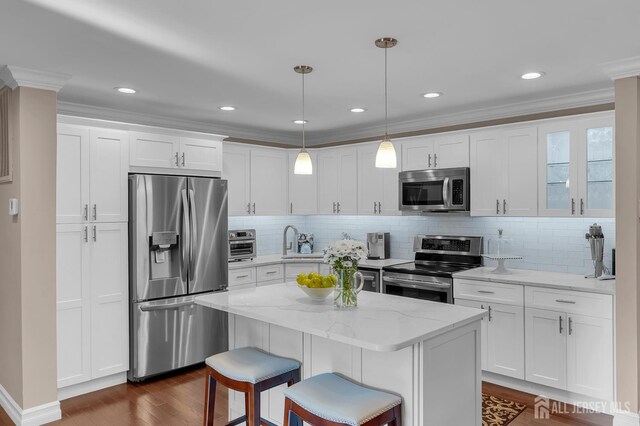 3 William Harrison Dr Unit A, Monroe, NJ 08831 - kitchen featuring appliances with stainless steel finishes, dark wood-style floors, a sink, white cabinetry, and tasteful backsplash