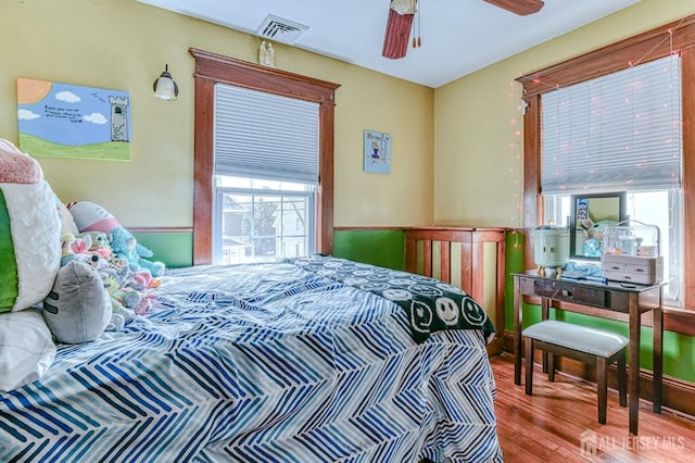 bedroom featuring visible vents and wood finished floors