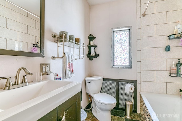 bathroom with toilet, vanity, and tile walls