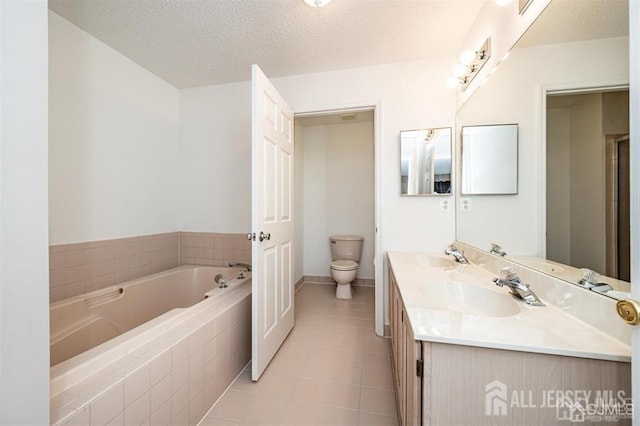 313 Prestwick Way, Edison, NJ 08820 - full bath featuring toilet, a garden tub, tile patterned flooring, double vanity, and a textured ceiling
