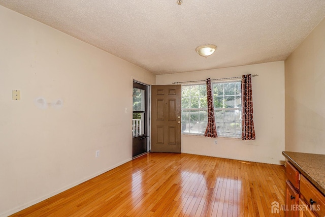 313 Prestwick Way, Edison, NJ 08820 - empty room with light wood finished floors, a textured ceiling, and baseboards