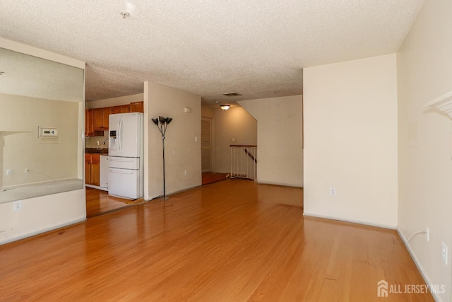 313 Prestwick Way, Edison, NJ 08820 - unfurnished living room featuring light wood-style flooring and a textured ceiling
