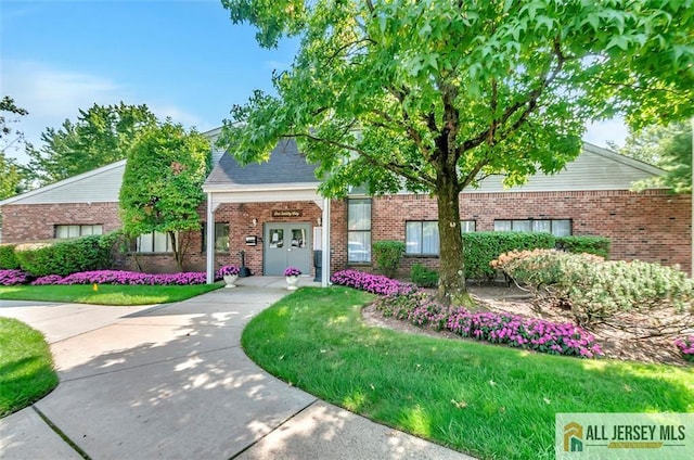 127 Pennsylvania Way N, Brunswick, NJ 08902 - view of front of home with brick siding, a front lawn, and french doors