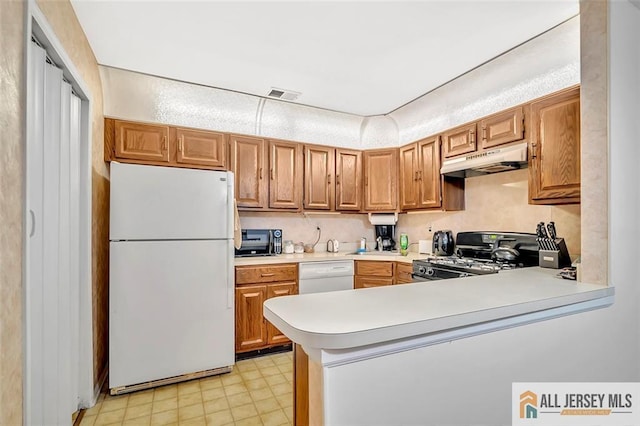 127 Pennsylvania Way N, Brunswick, NJ 08902 - kitchen with white appliances, under cabinet range hood, light countertops, a peninsula, and light floors