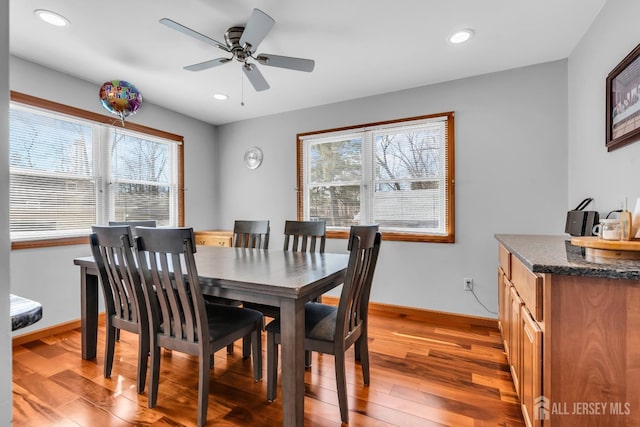 dining space with baseboards, light wood finished floors, a ceiling fan, and recessed lighting