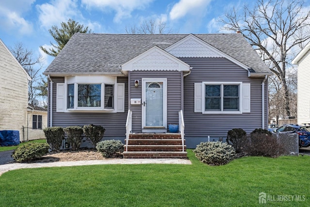 bungalow-style home featuring a shingled roof and a front lawn