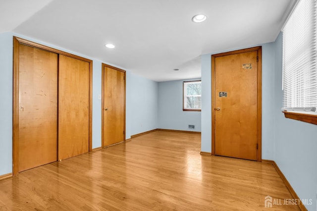 interior space featuring light wood finished floors, recessed lighting, and baseboards