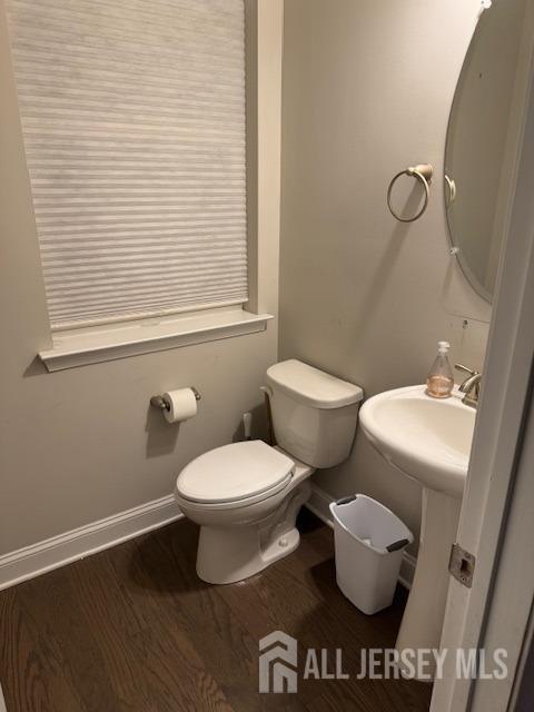 bathroom featuring hardwood / wood-style floors and toilet