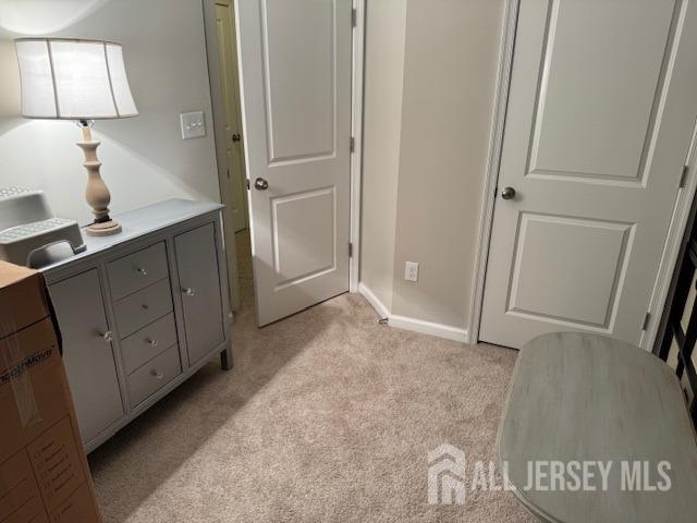 bedroom featuring light carpet