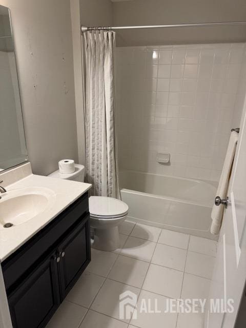 full bathroom featuring tile patterned flooring, shower / tub combo, vanity, and toilet