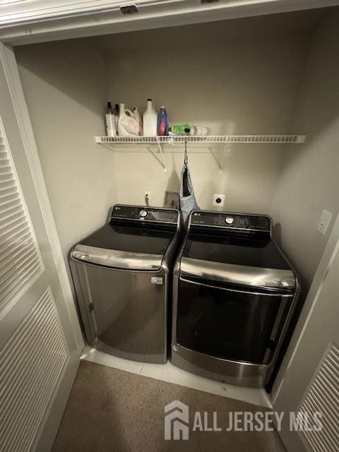 washroom with tile patterned flooring and separate washer and dryer